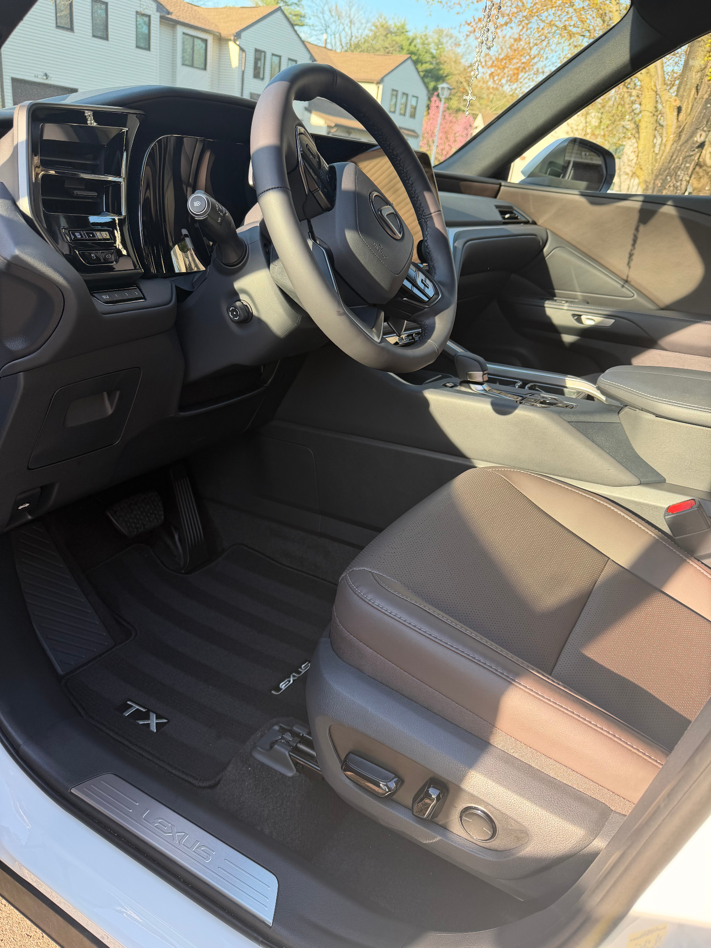 Lexus TX passenger interior detailed with spotless leather seat and floor mat