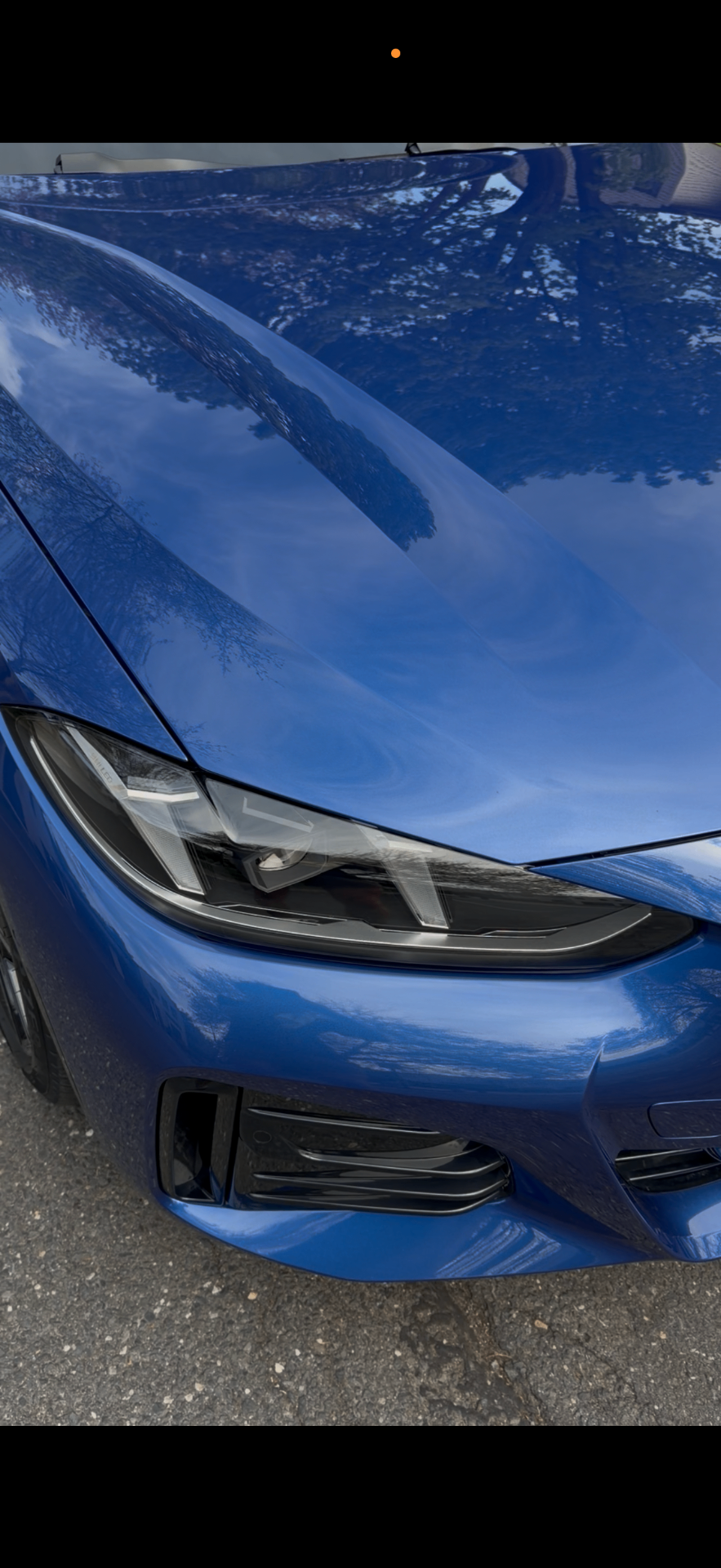 Blue paint finish reflecting the sky after correction and detail